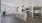 Model kitchen at our townhome and apartment community in Trumbull, featuring stainless steel appliances, counter seating, and wood laminate floors. 