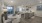 Model dining room at our apartments in Trumbull, featuring a dining room table, view of the kitchen and living room and a balcony overlooking lush, landscaped grounds.